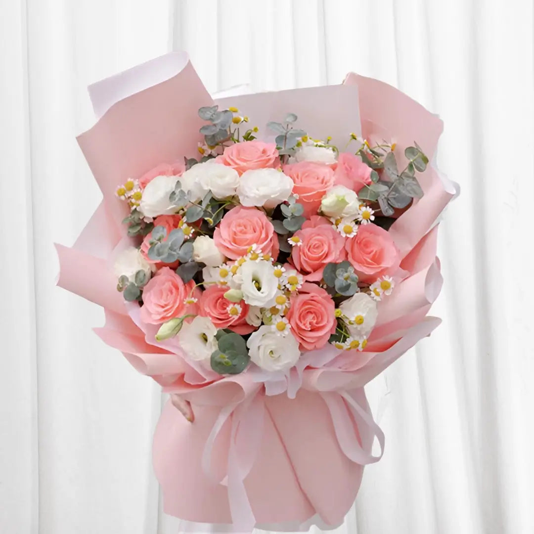 Blush & Bloom Floral Bouquet featuring pink roses, white lisianthus, chamomile, and eucalyptus in soft, elegant wrap.