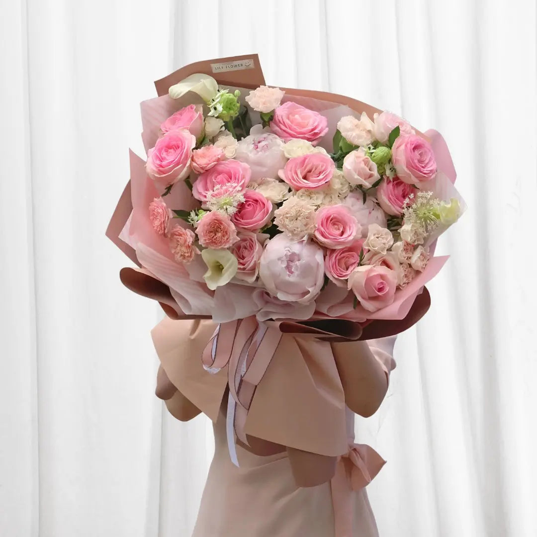 Bouquet of 9 pink roses, 2 peonies, 1 white calla lily, and 3 light pink carnations