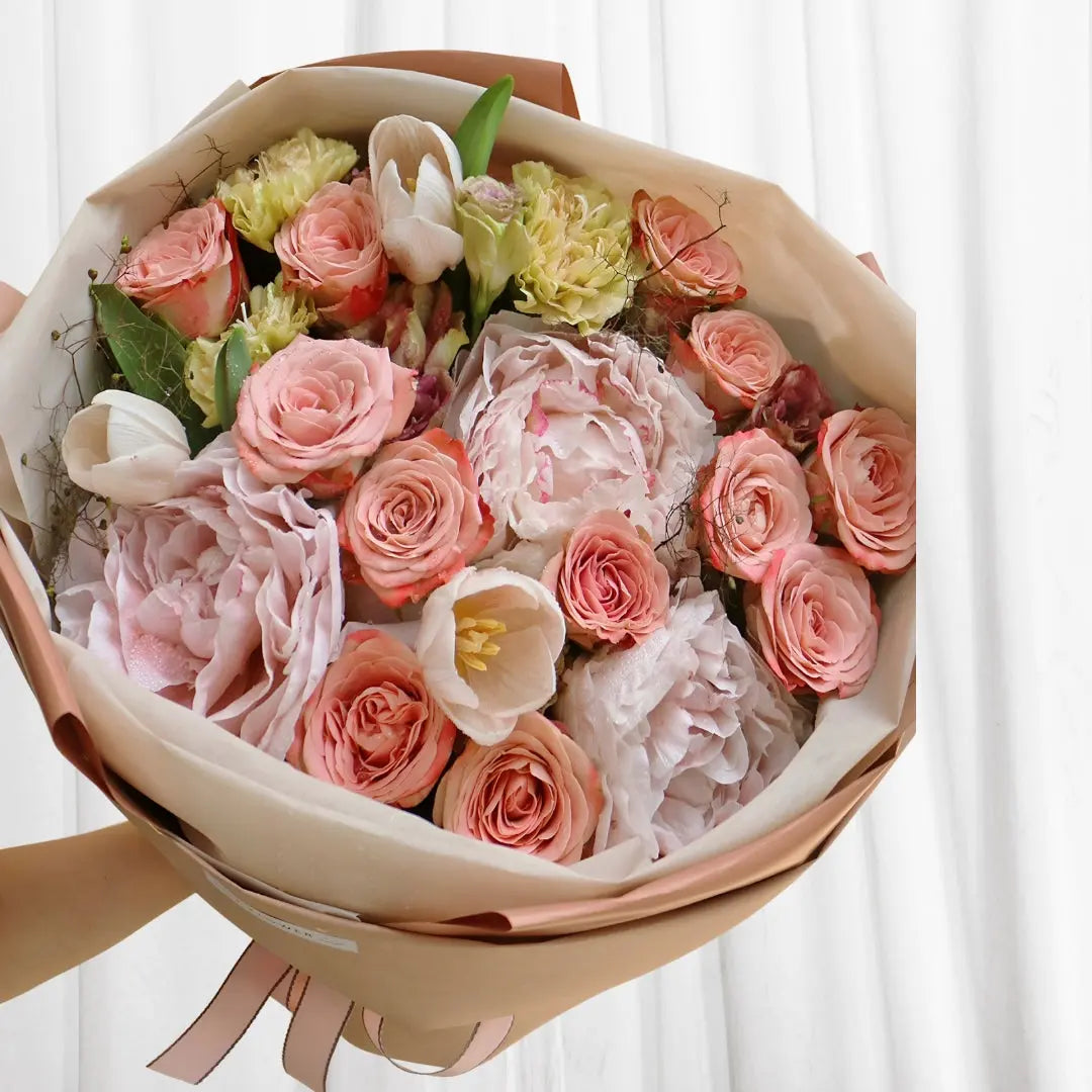 Elegant Pink Serenity Bouquet with soft pink roses, peonies, white tulips, and delicate greenery